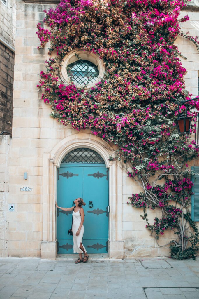 Ancient doors of Malta with colourful flowers