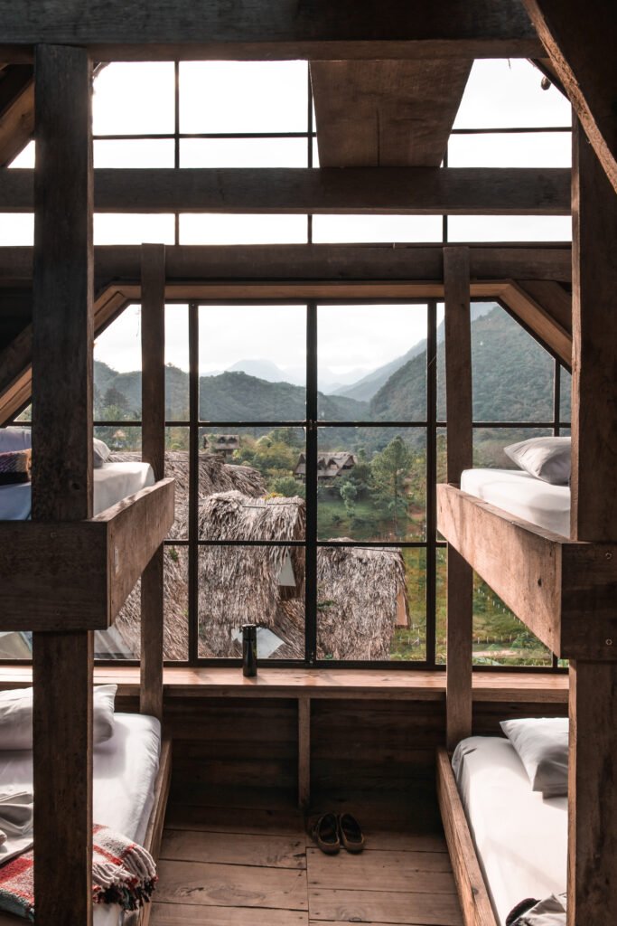 The bedroom room from the hostel Zephyr Lodge into the surrounding mountains of Guatemala in Lanquin