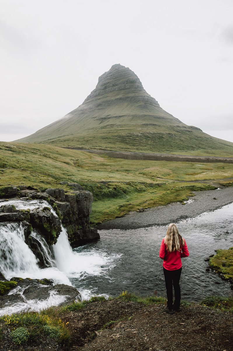 Girl looking out at Kirkjufell from the waterfall in Iceland