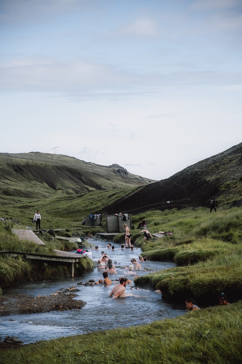 People bathing in the Reykjadalur Thermal River in Iceland