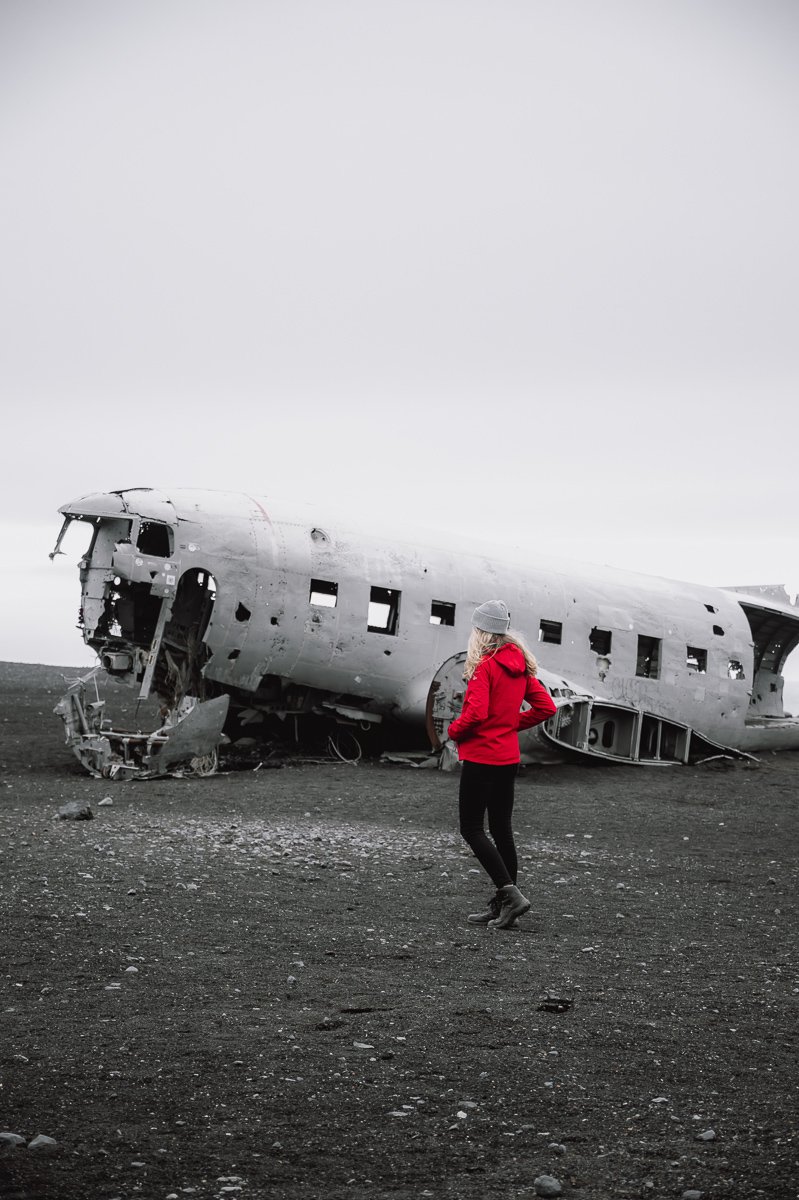 Girl walking towards the Sólheimasandur Plane Wreck in Iceland just off the Iceland Ring Road