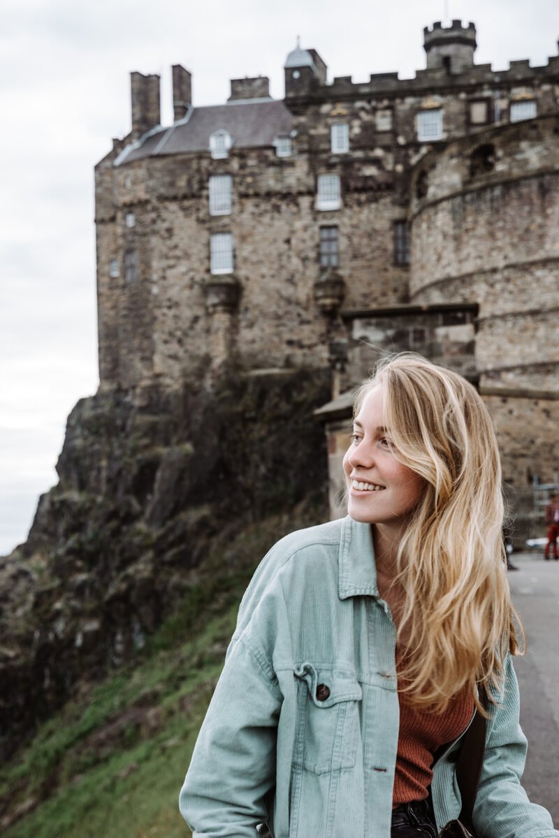 Girl sitting in front of Edinburgh Castle