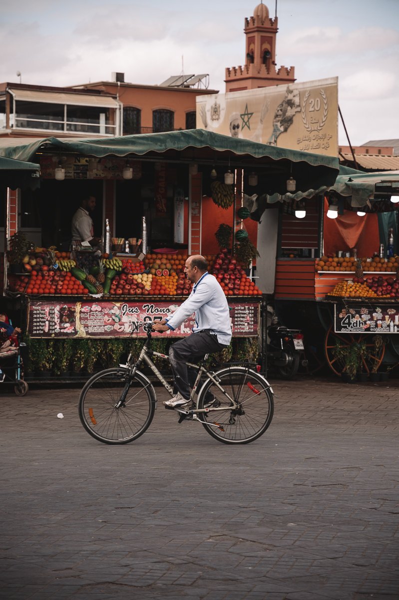 A bike rider in the the Plaza Jemaa el Fnaa in Marrakech