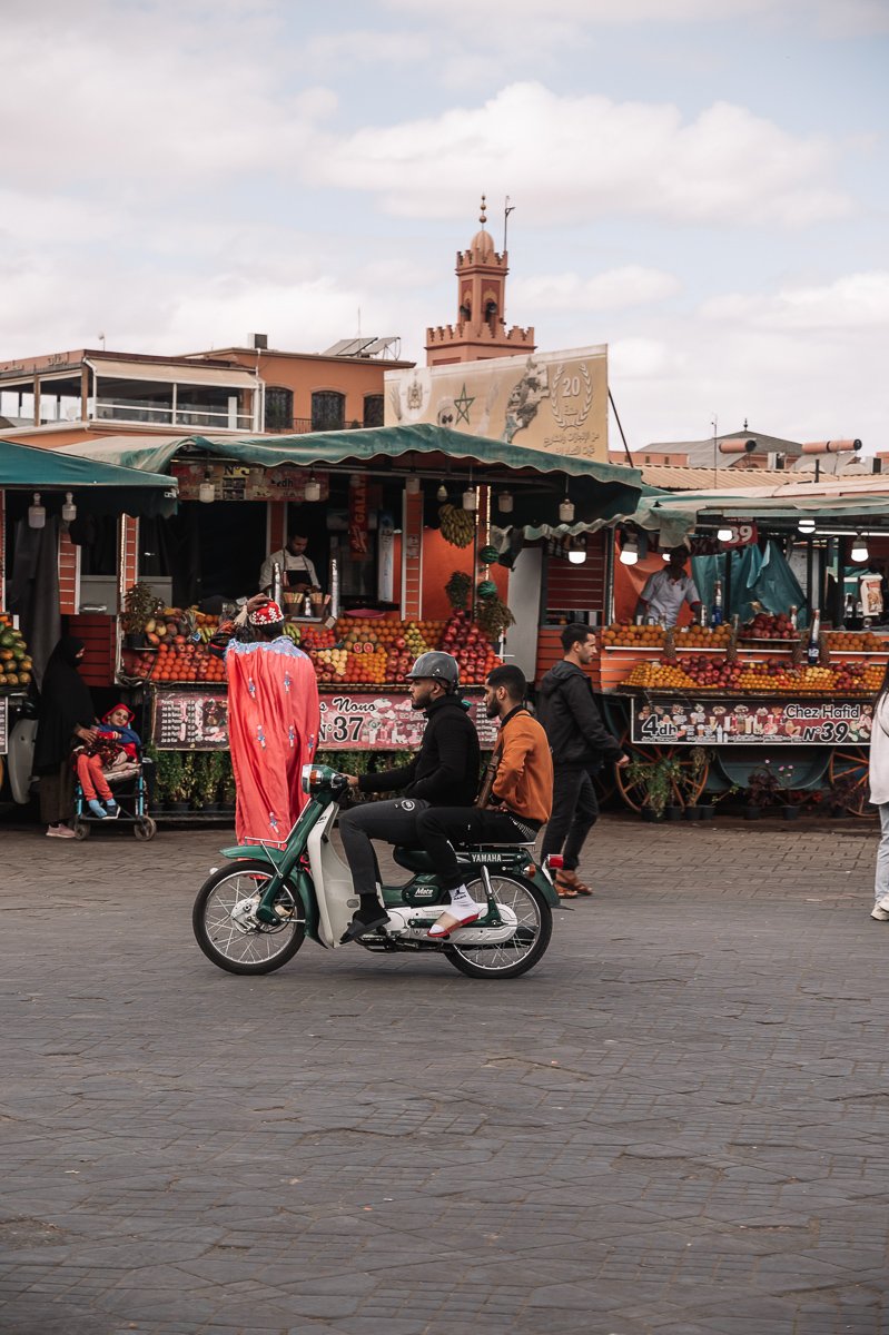 A motorbike rider in the the Plaza Jemaa el Fnaa in Marrakech