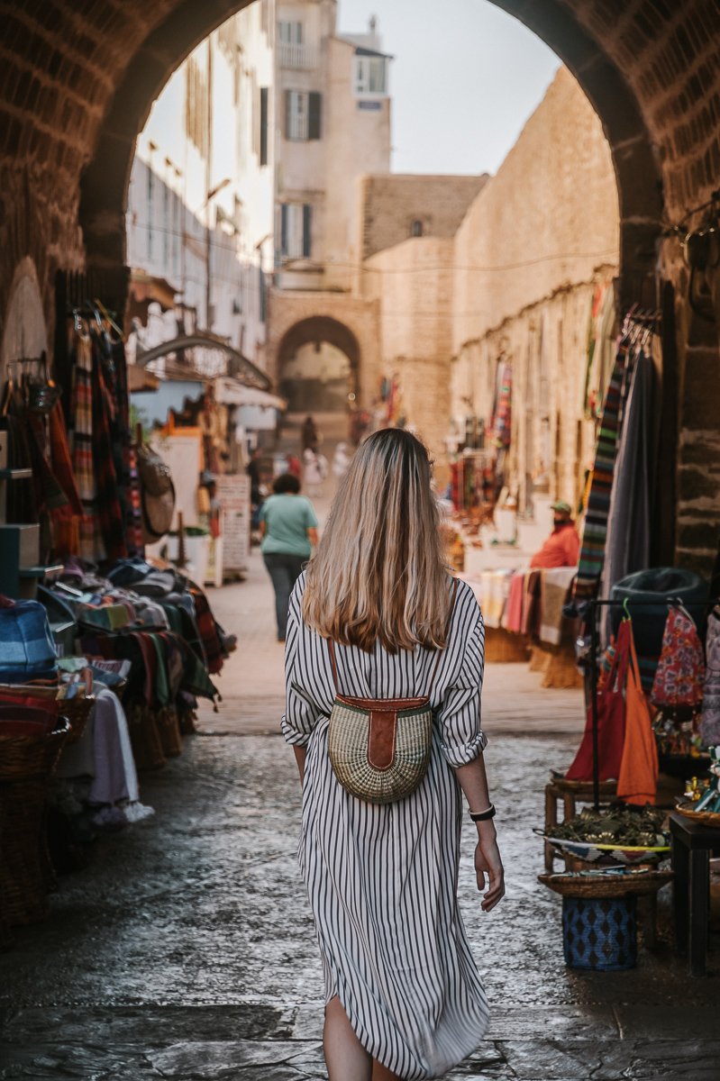 A girl walks within the Essaouira Medina