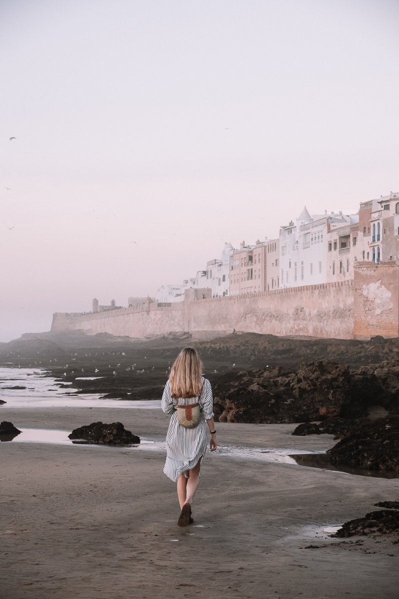 A girl walking towards the Essaouira Medina Walls